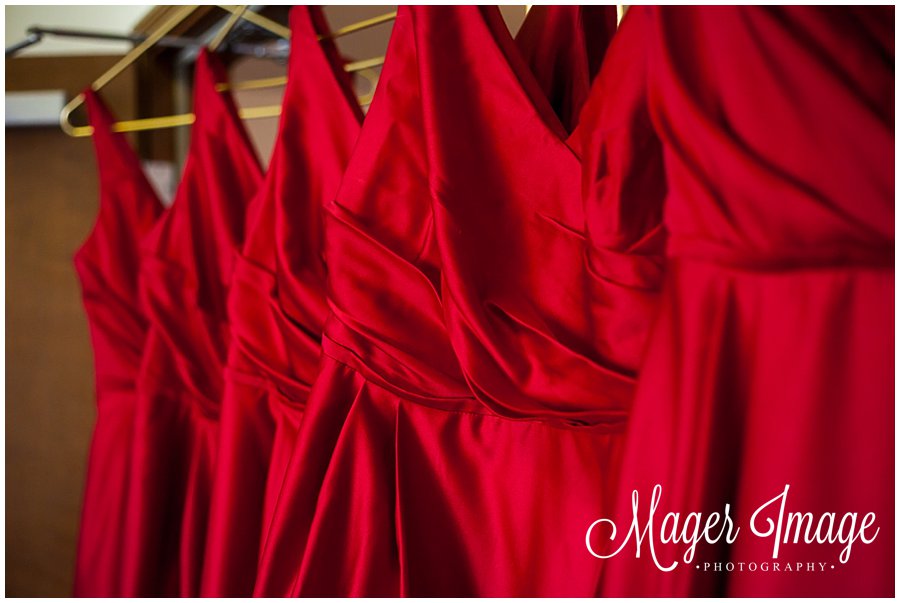 red bridesmaid dresses hanging on gold hangers