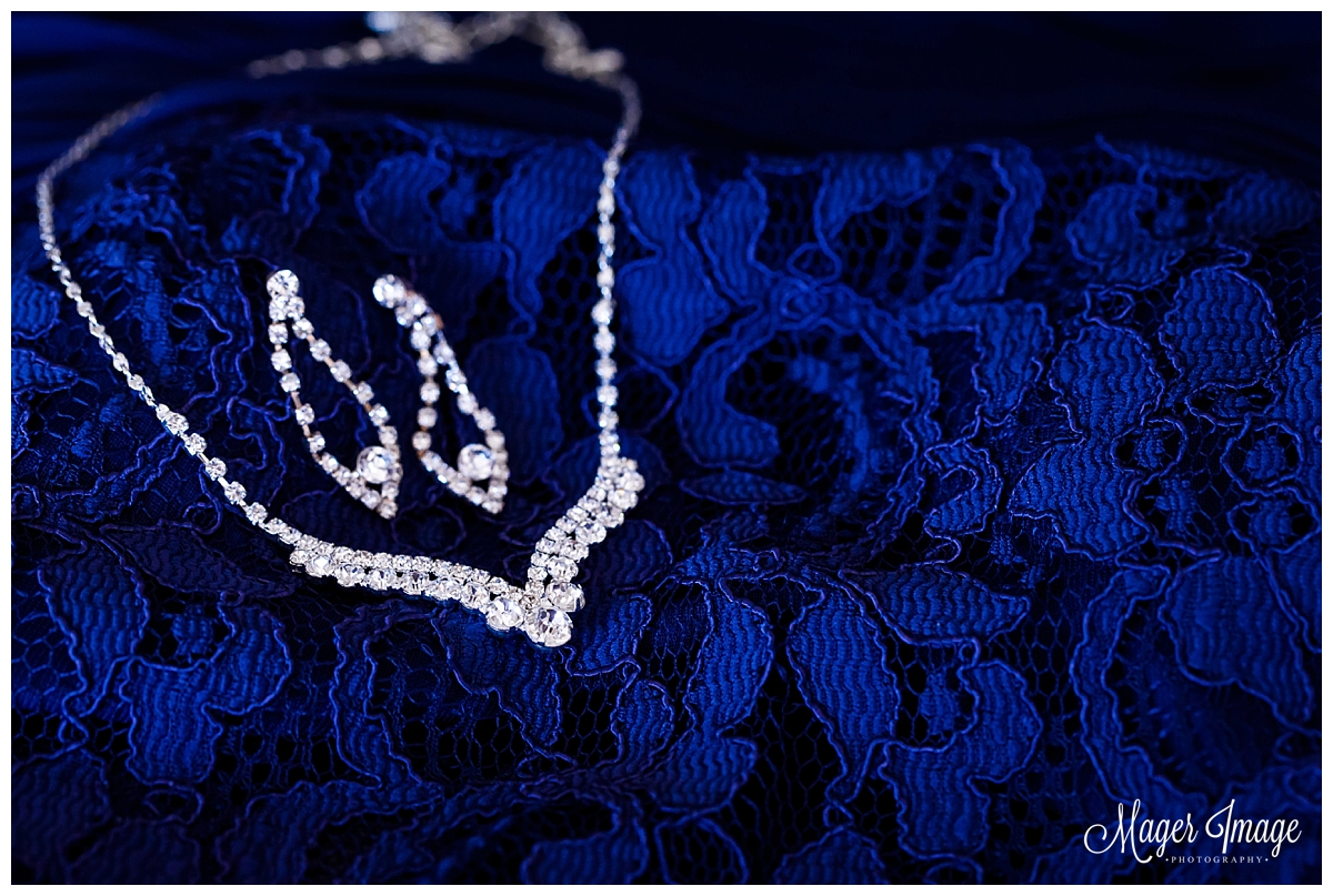 navy dress with necklace and diamond earrings