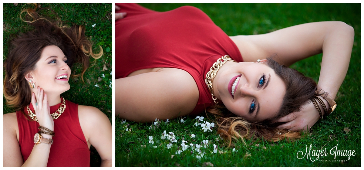 senior girl laying on grass in red dress