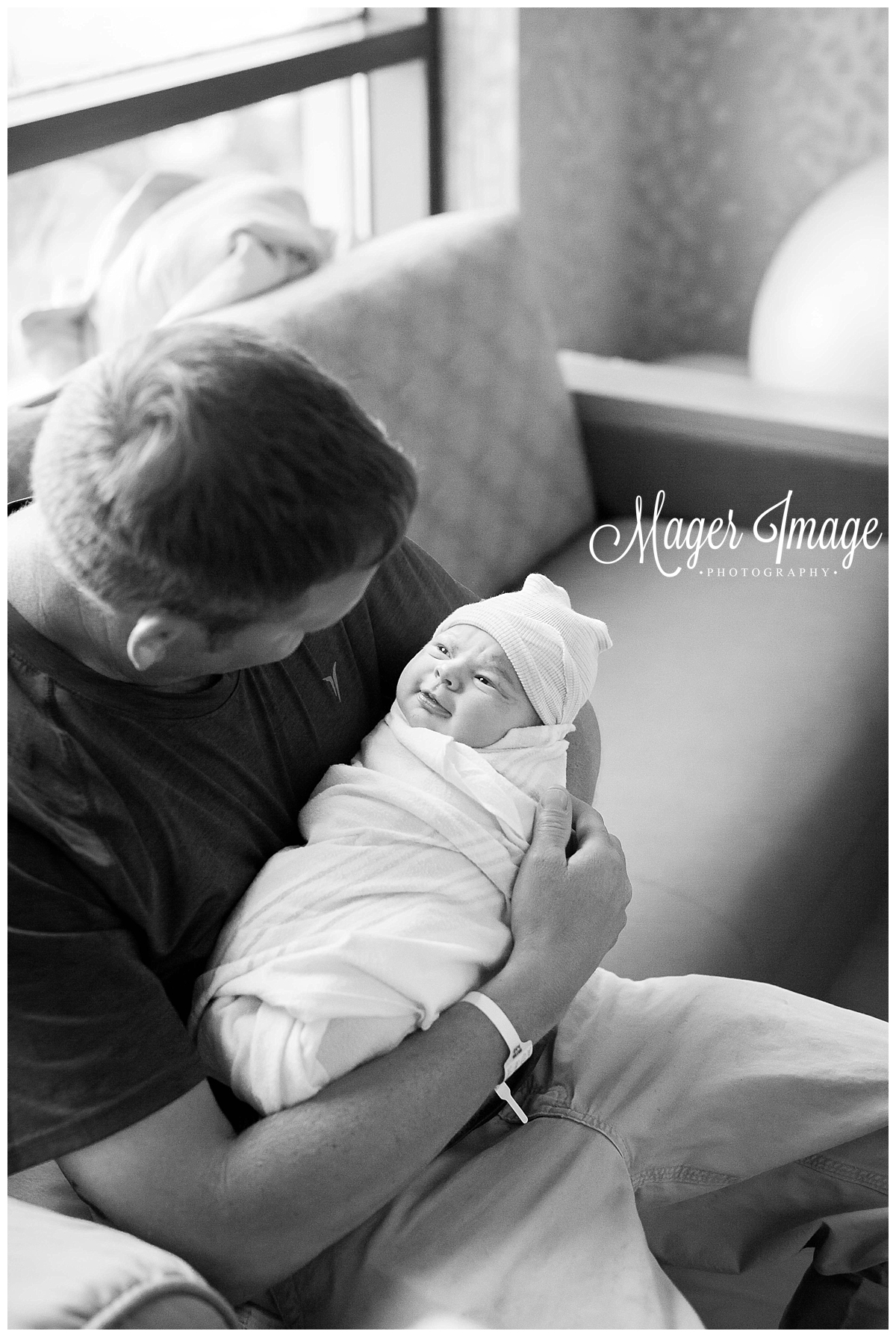 dad holding his newborn daughter