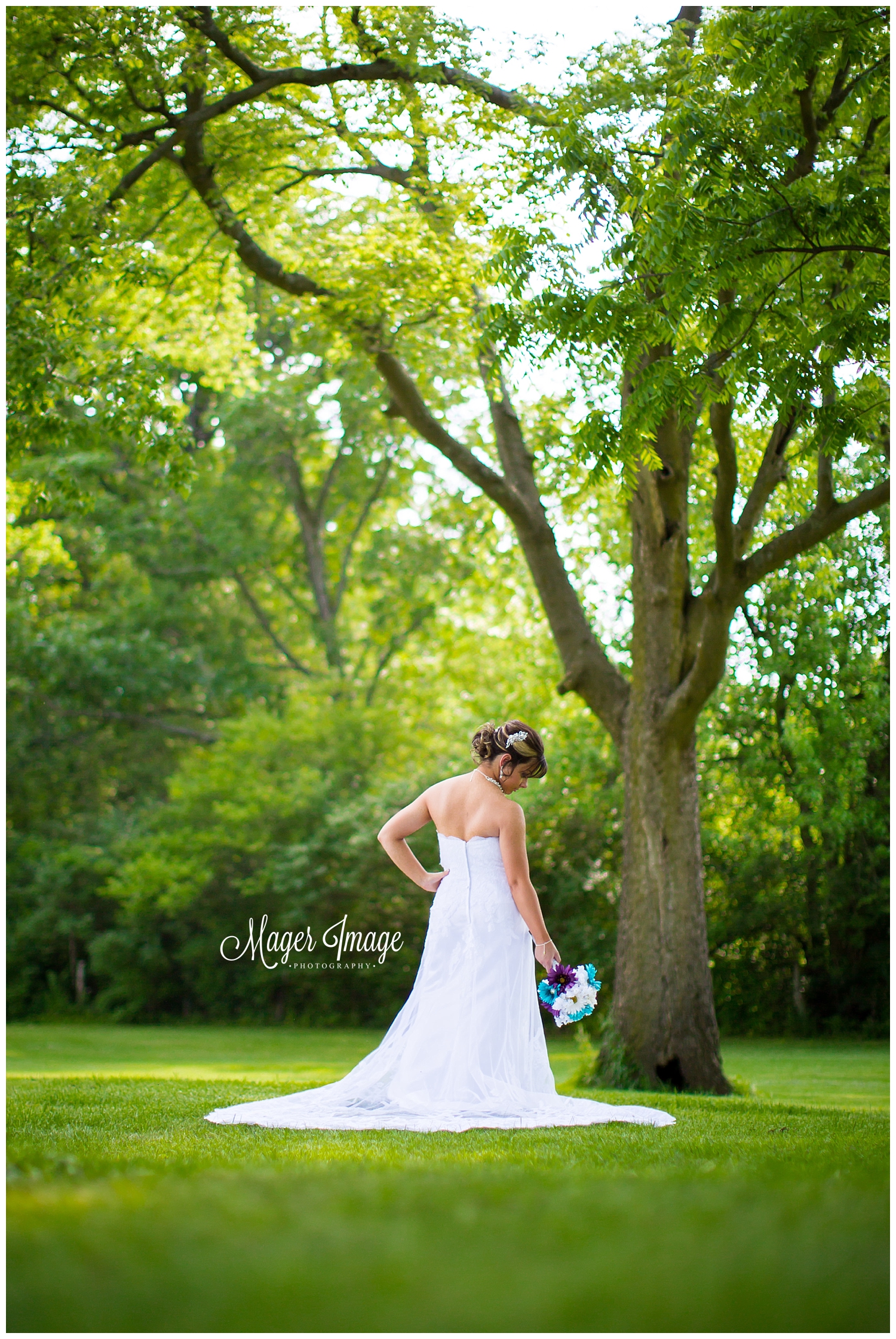 bride standing amongst trees