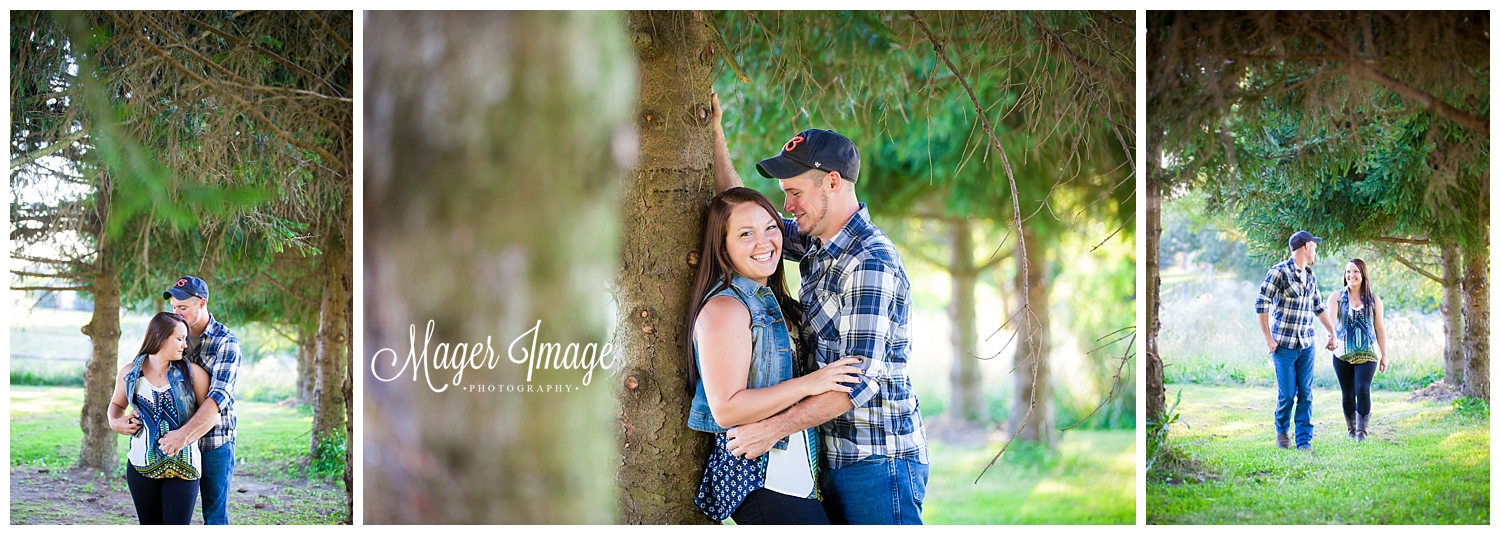 couple under pine trees posing