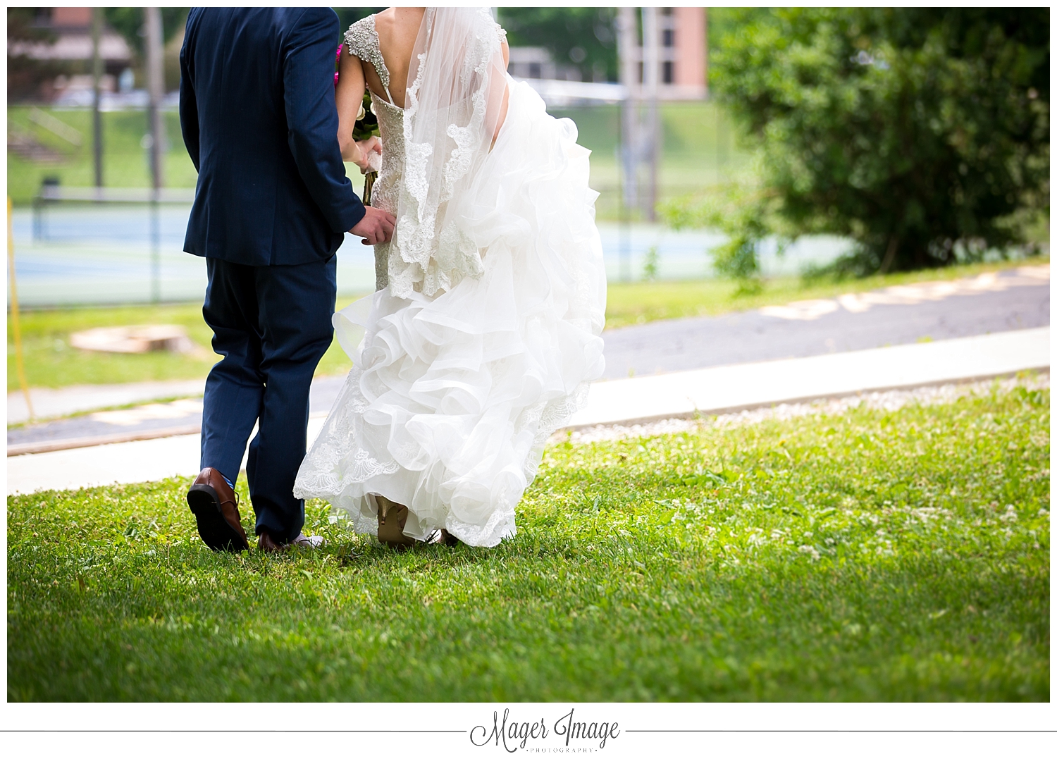 unposed moment bride groom walking dress train