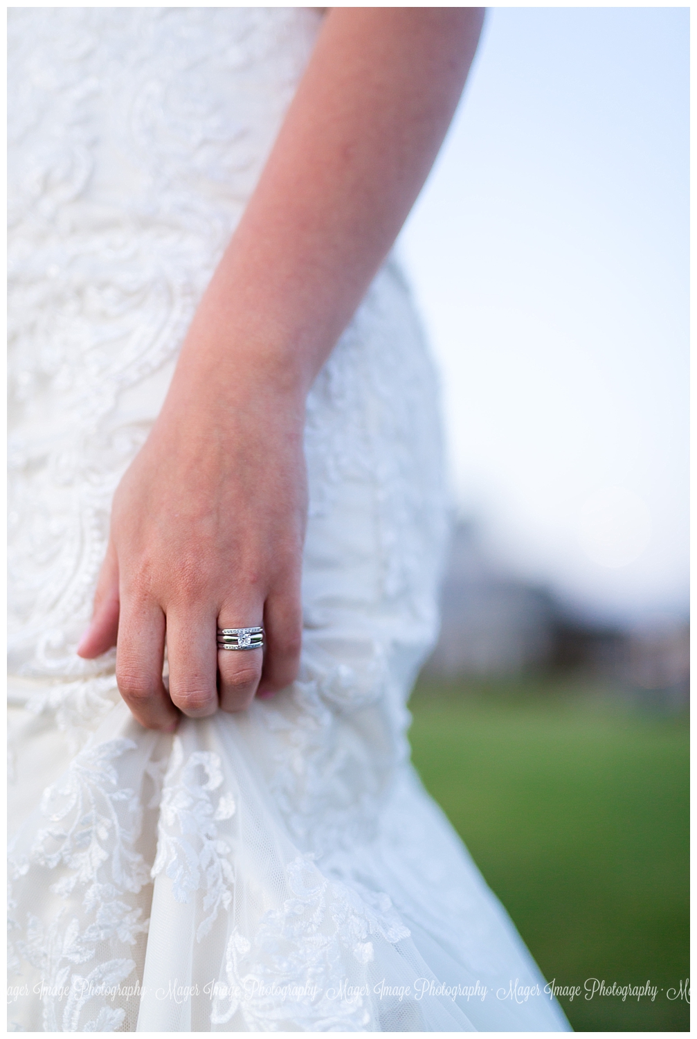 bride holding dress ring shot