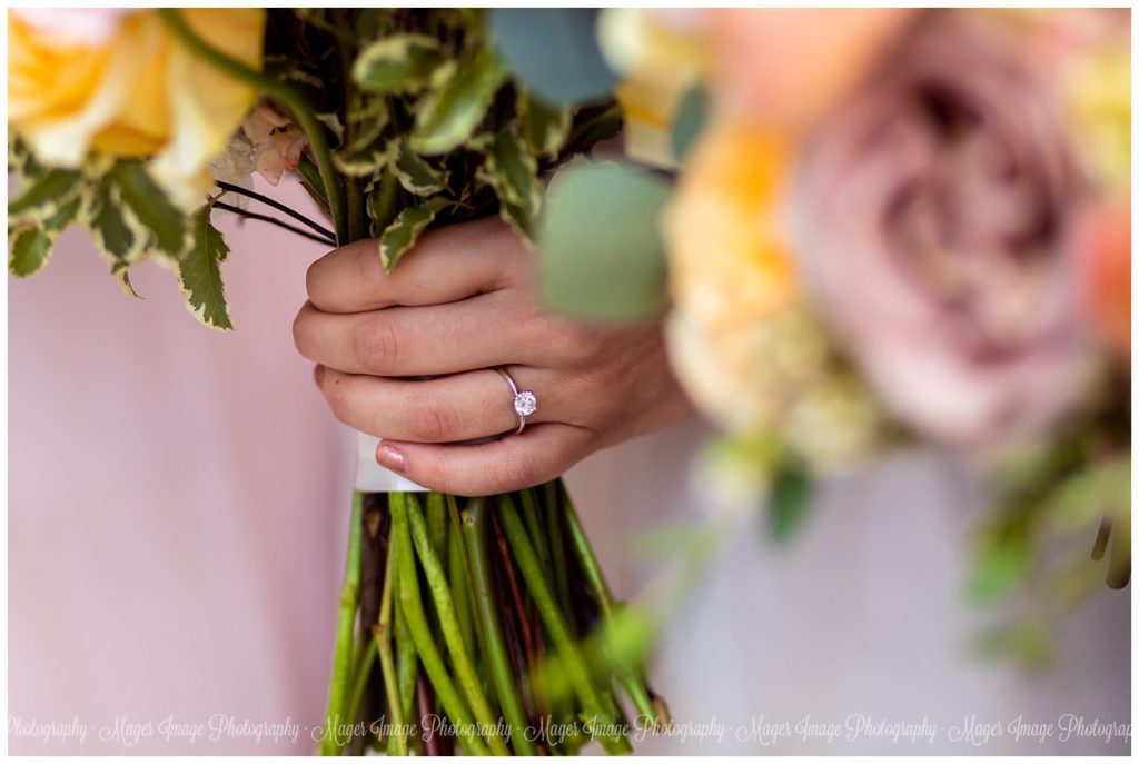 ring shot holding flowers wedding