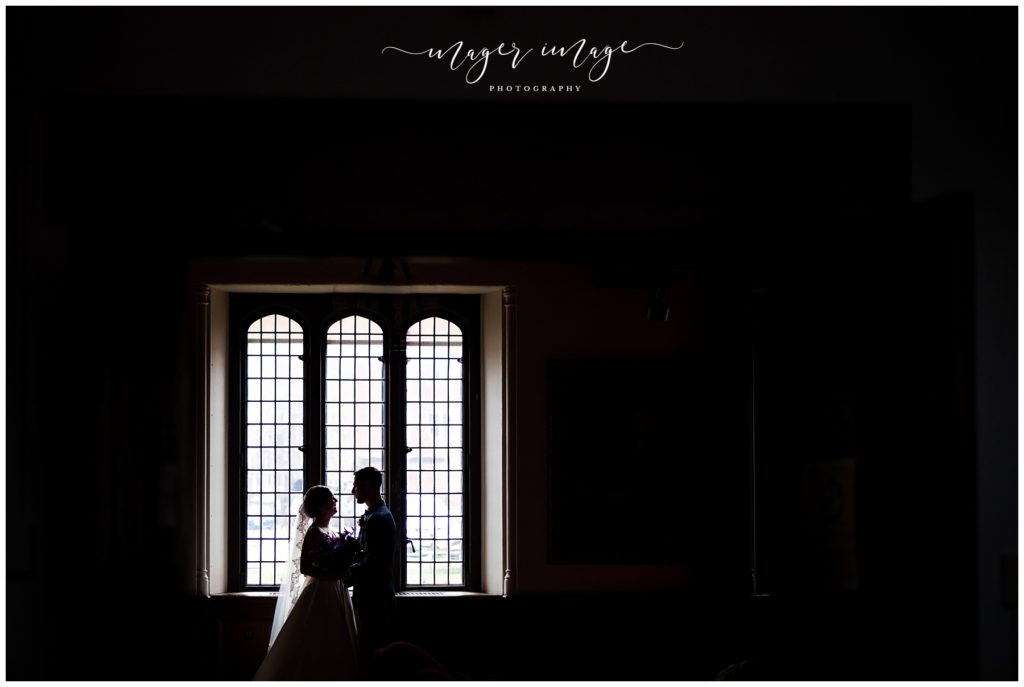 sillhouette photo bride groom chapel window