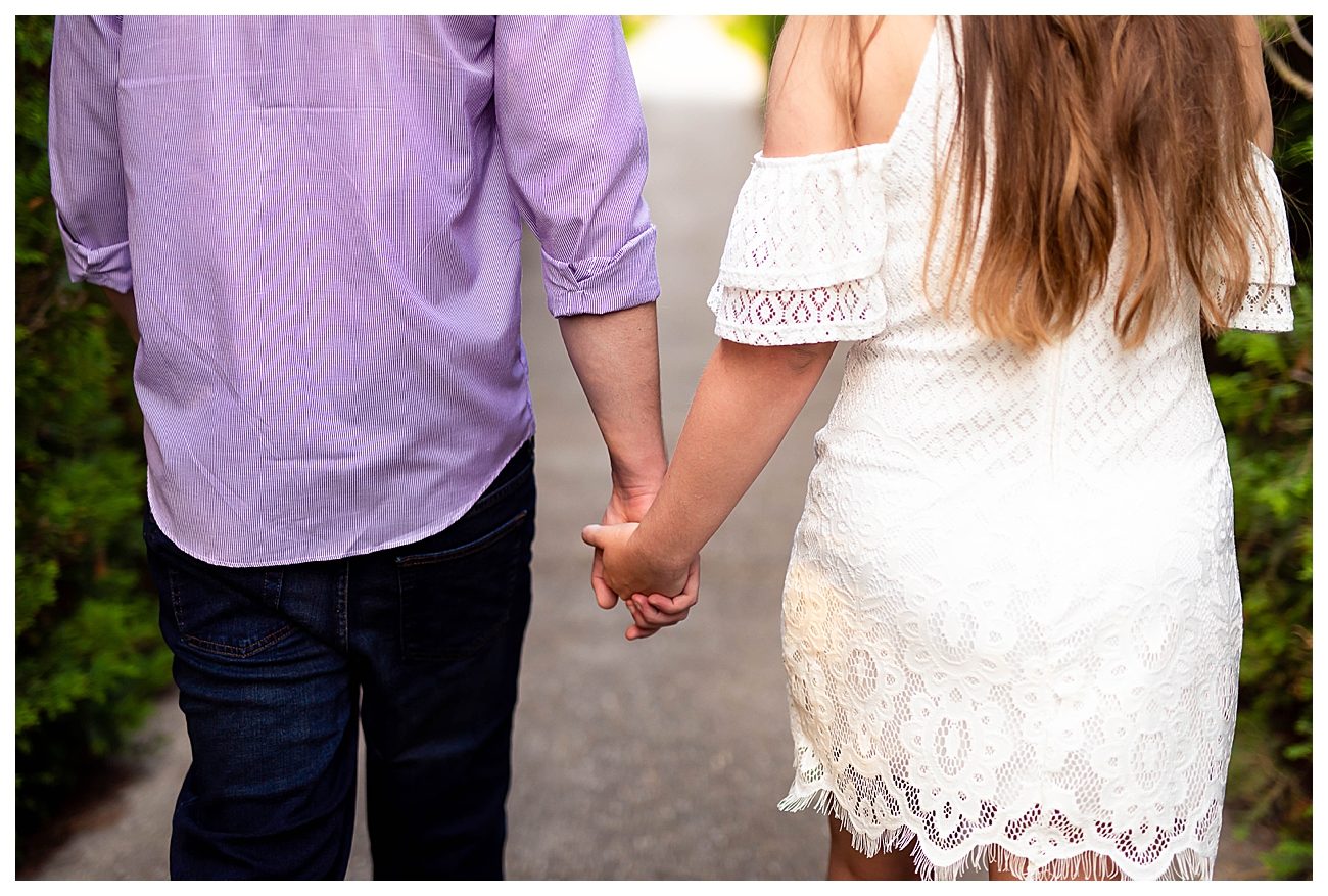 couple holding hands summertime engagement session