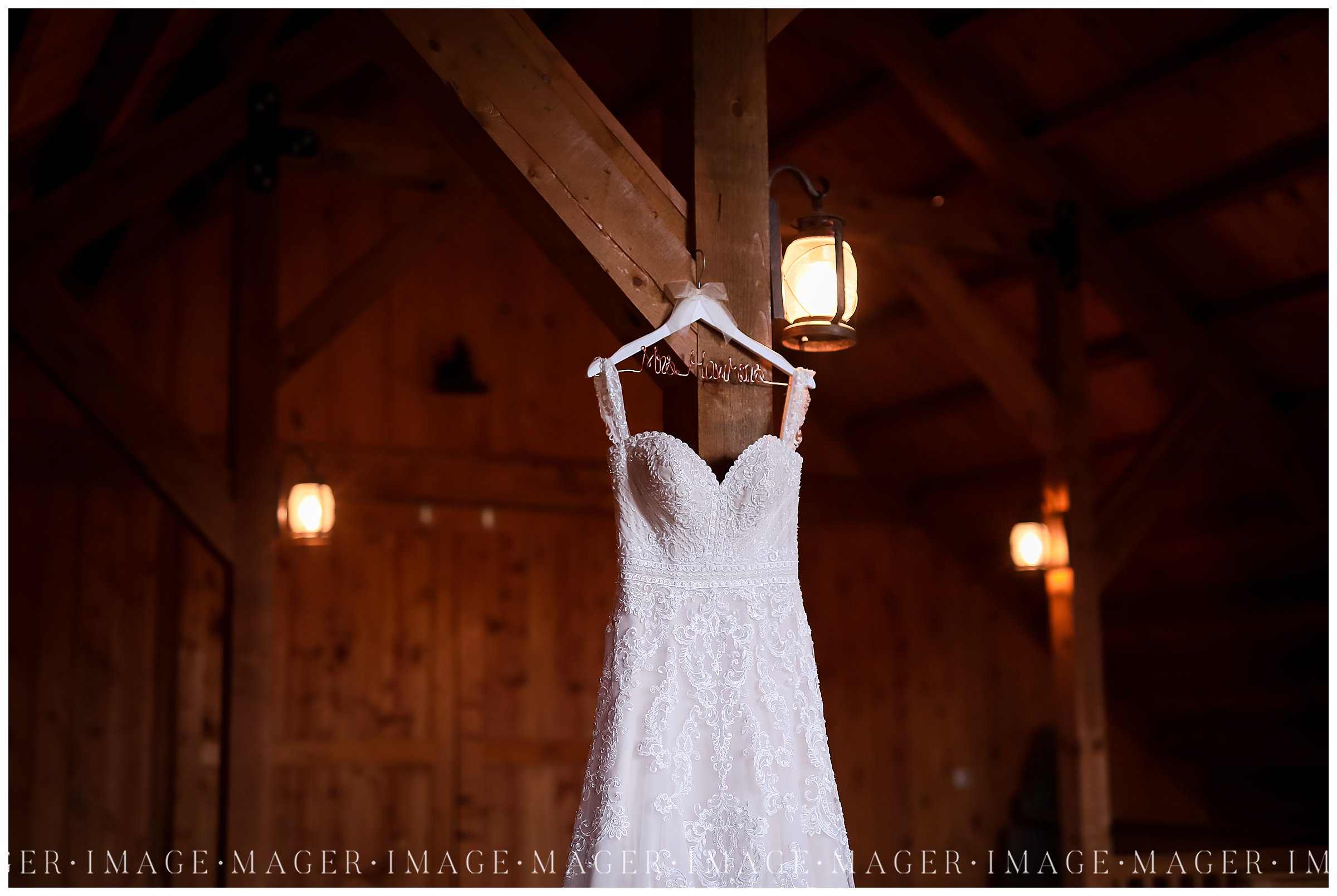 wedding dress details hanging in barn 