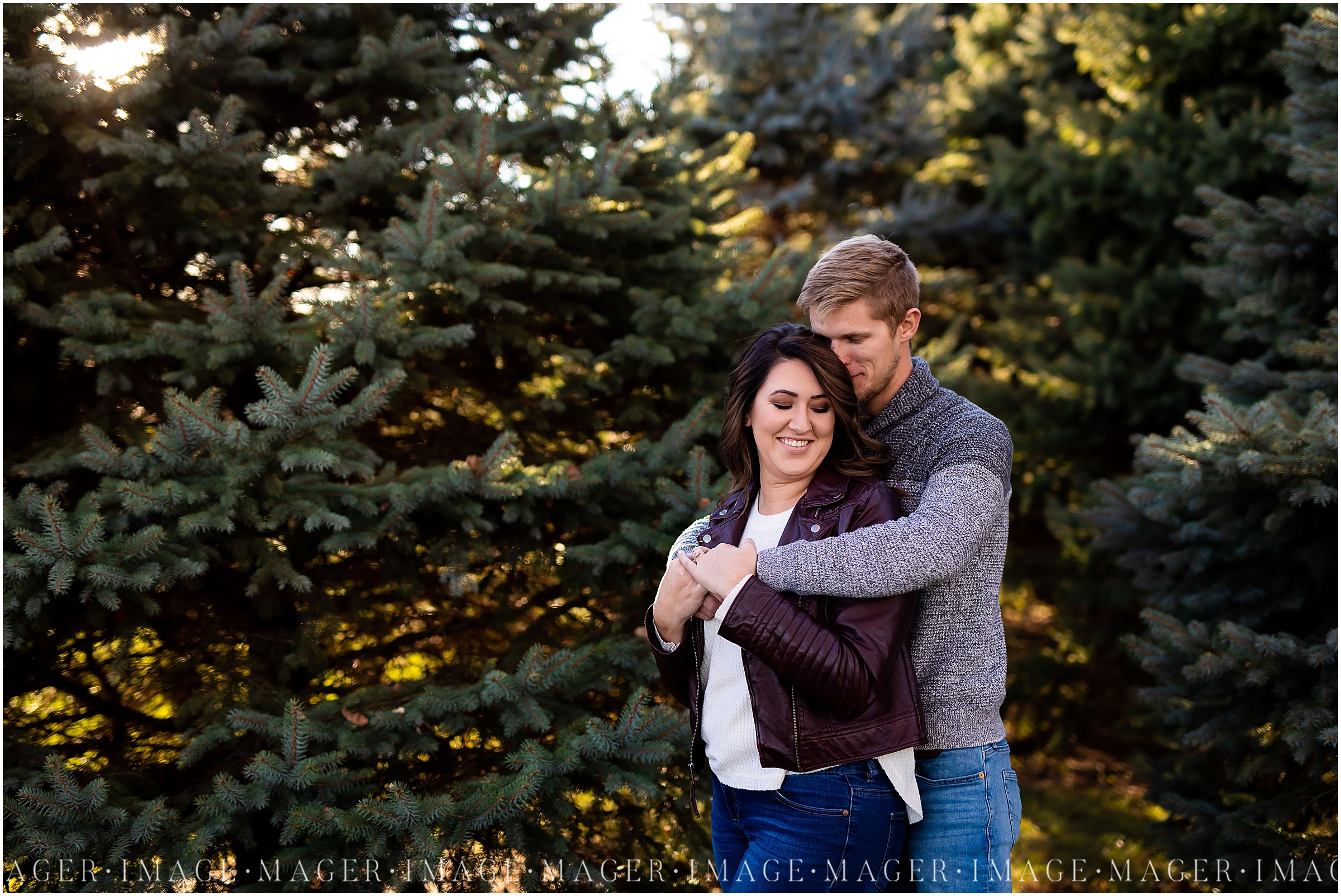 A couple poses in the evergreen trees at Ten Mile Grove in Paxton, IL. 

Photos by Mager Image Photography.