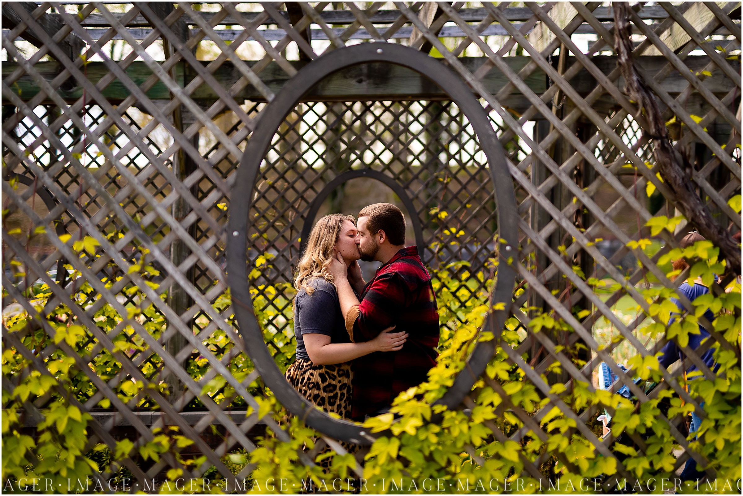 springtime garden engagement session, couple kissing in garden