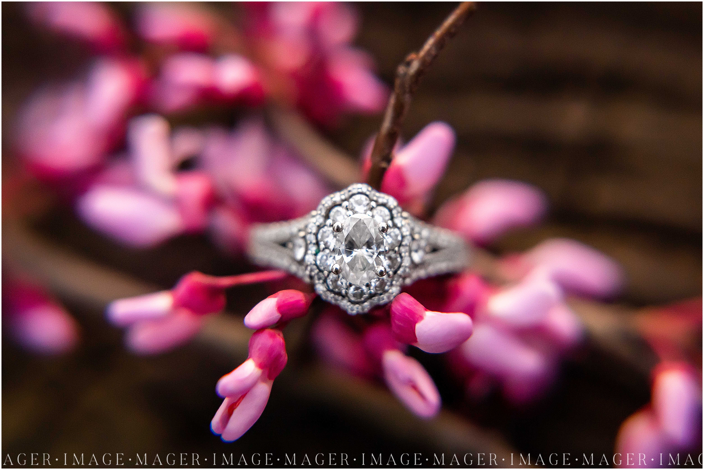 old fashioned style engagement ring on pink springtime blooming flower