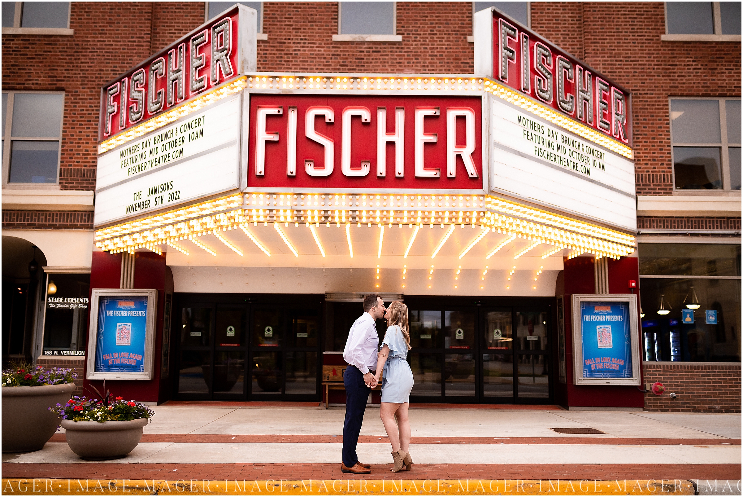 A beautiful downtown Danville, IL engagement session. A couple stands holding hands and kissing beneath a theater marquee sign that reads their future wedding date. 

Photo taken by Mager Image Photography 