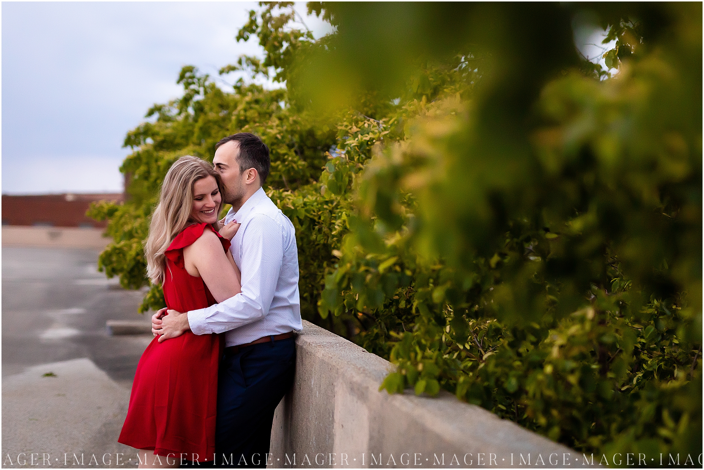 A couple embraces near greenery while leaning against a concrete wall in downtown Danville, IL.

Photo taken by Mager Image Photography 