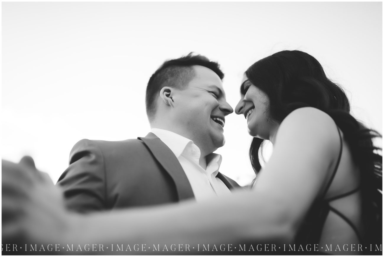 A black and white image of a couple laughing. Taken at the Idea Gardens in Champaign, IL

Photo taken by Mager Image Photography.