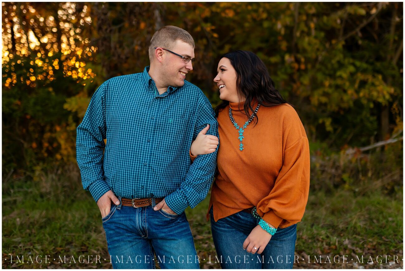 walk and talk pose on orange and teal couple