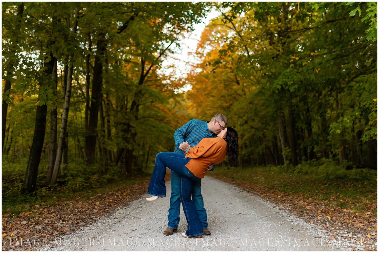 road in fall couple dip for a kiss