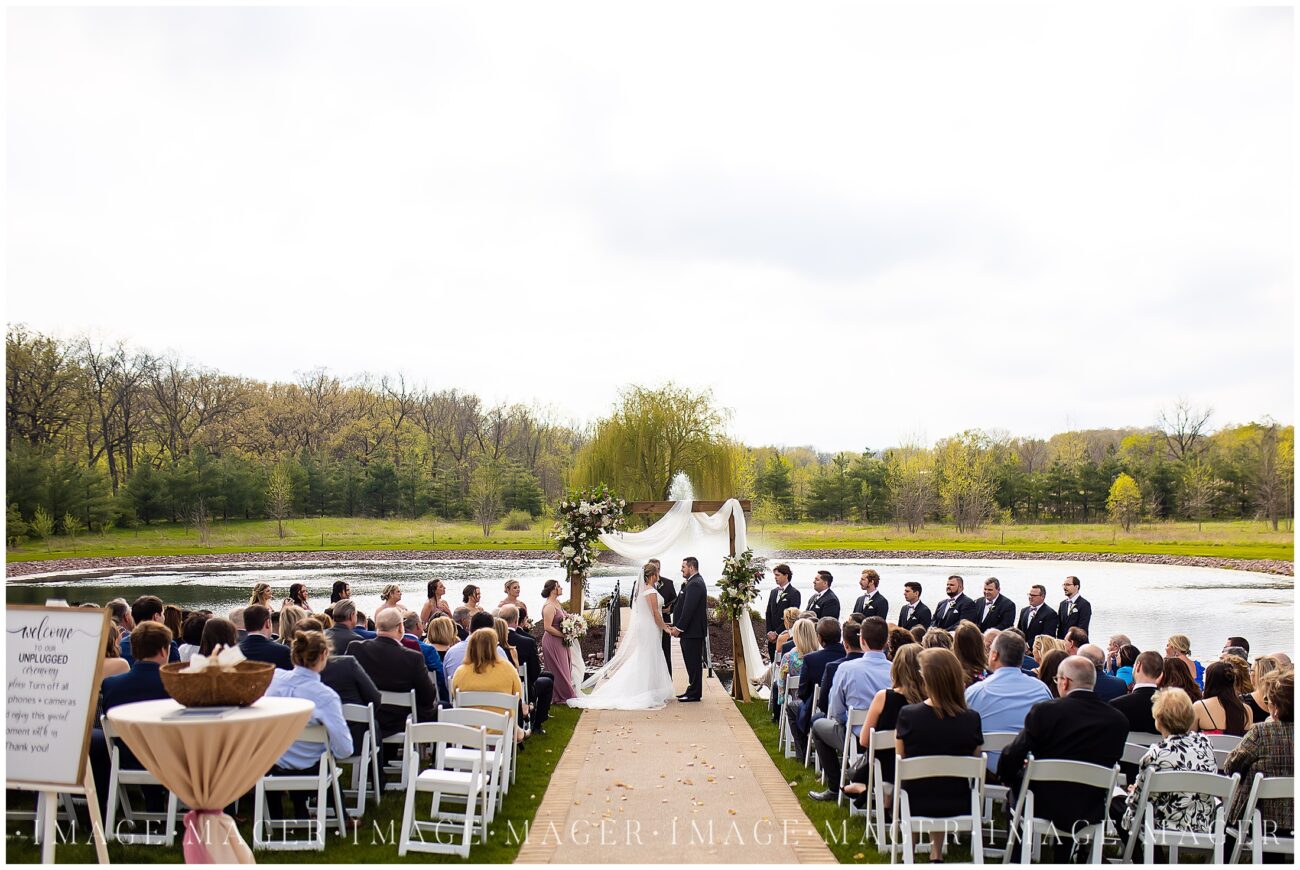 Outdoor wedding ceremony overlooking pond