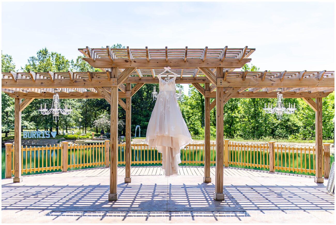 blush wedding dress hanging outside whitetail estate