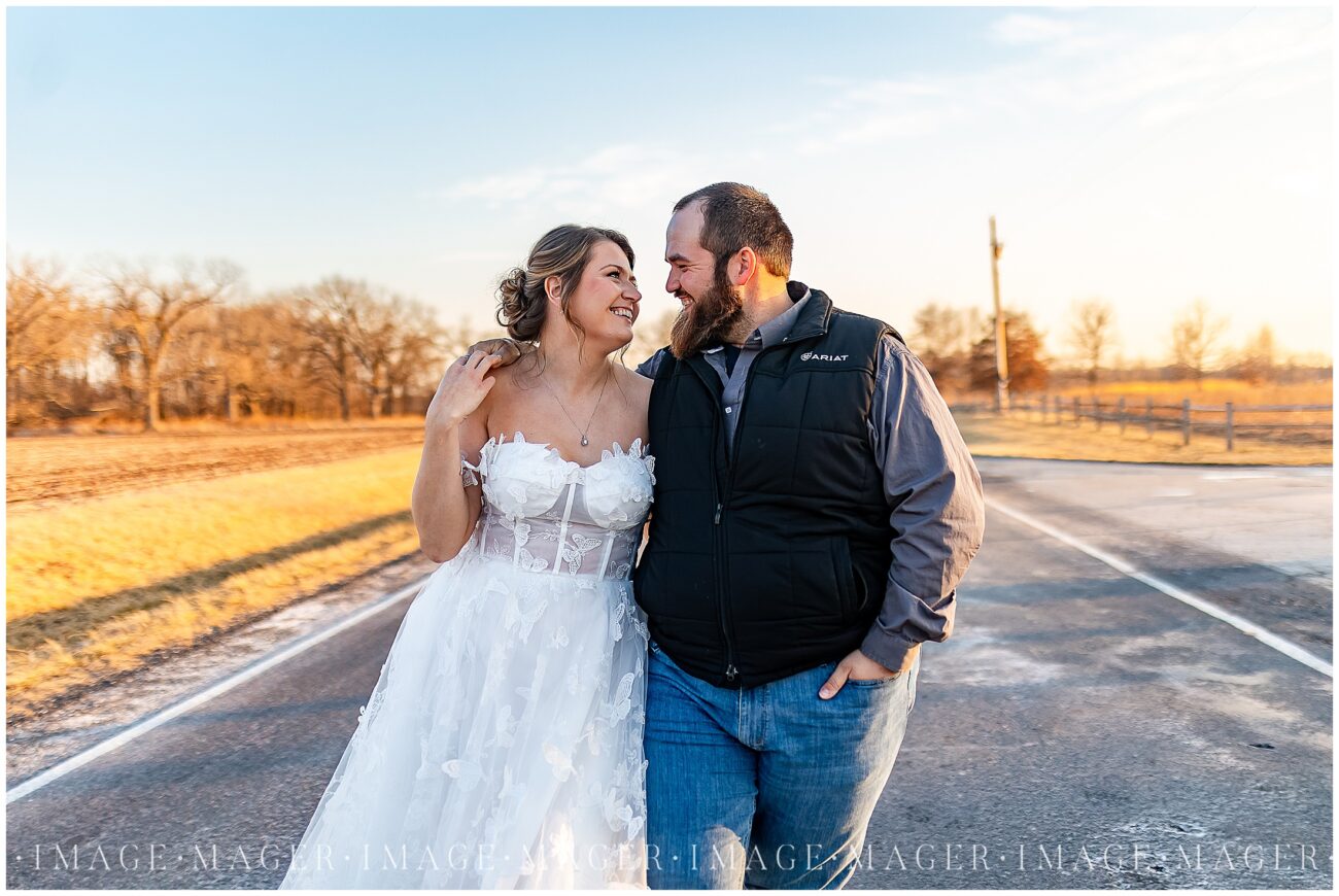 winter engaged couple on paved line road