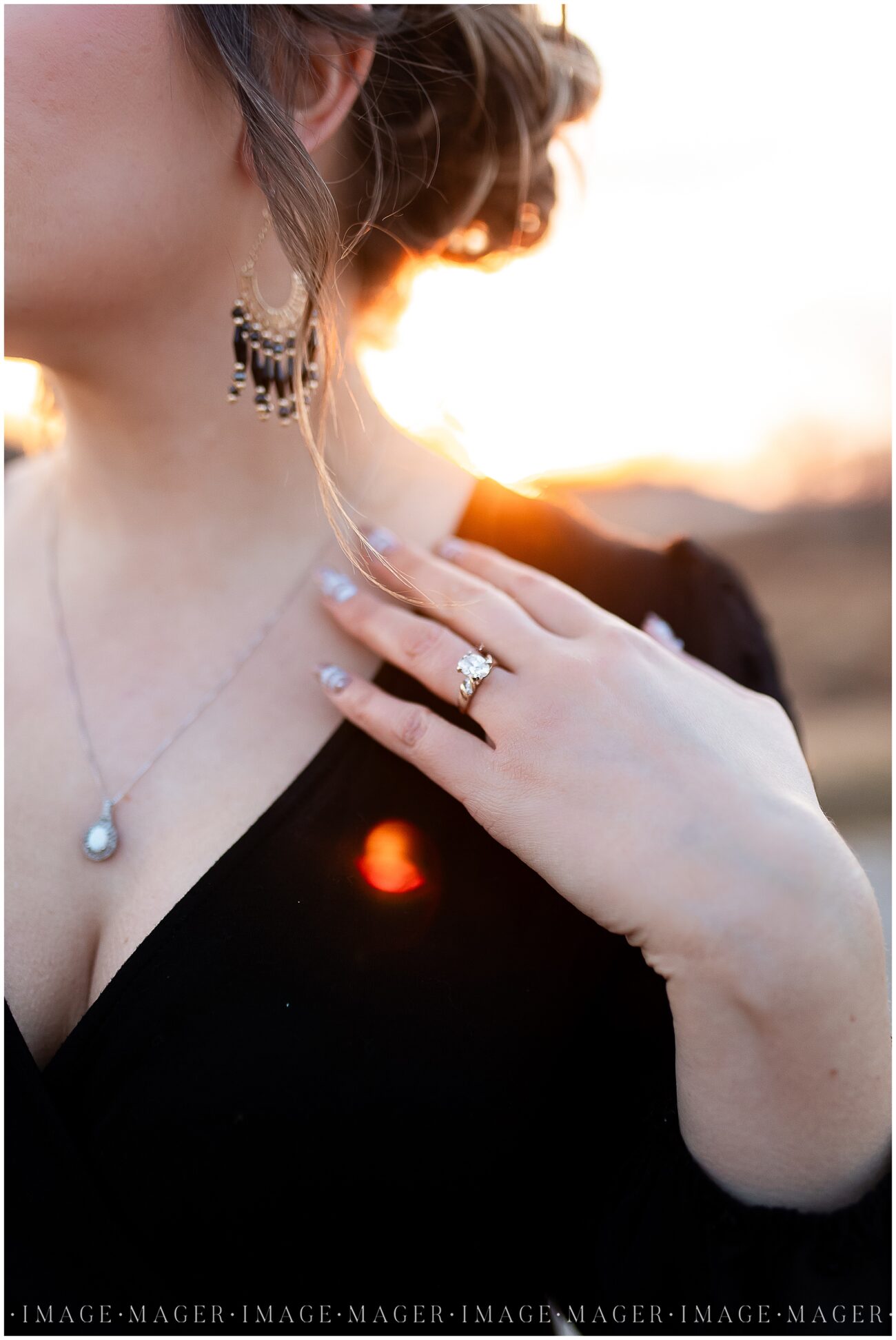 womans heirloom engagement ring at sunset