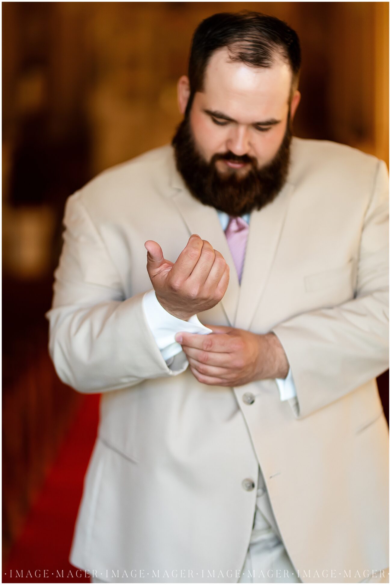 A small town wedding getting ready photo of the groom putting on his cuff links.

L'erable, IL. Photo taken by Mager Image Photography.