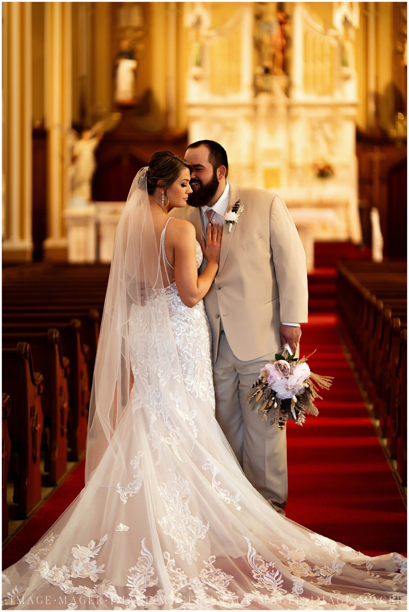 A small town wedding for Casey and Adam. A close-up portrait of the bride and groom in the church showing off the back of the bride's dress.

Saint John the Baptist Catholic Church, L'erable, IL. 

Photo taken by Mager Image Photography.