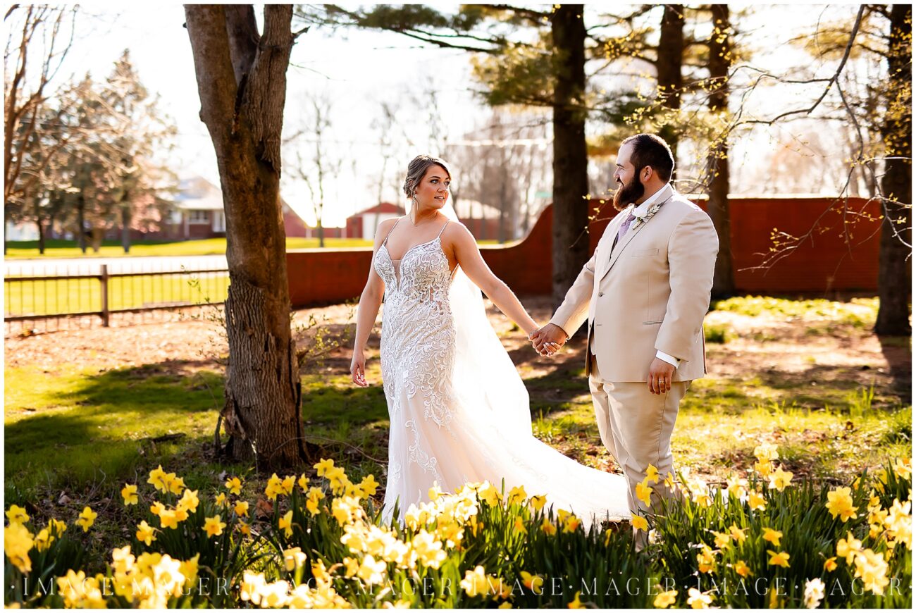 A small town wedding for Casey and Adam. The bride and groom walking amongst yellow flowers with trees and land behind them. The light is soft and glowing around them.

Saint John the Baptist Catholic Church, L'erable, IL. 

Photo taken by Mager Image Photography.