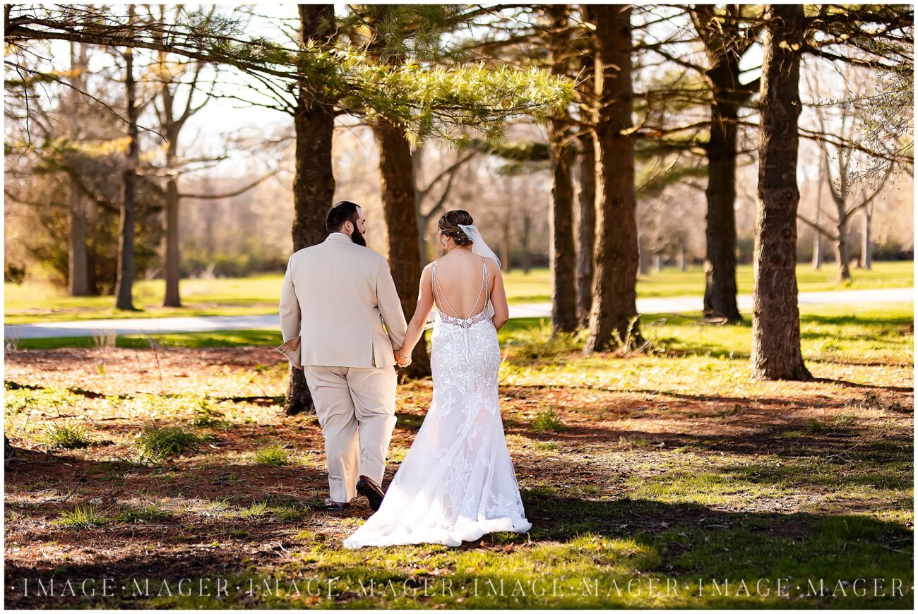 A small town wedding for Casey and Adam. The bride and groom walk away from the camera along the tree line.

Saint John the Baptist Catholic Church, L'erable, IL. 

Photo taken by Mager Image Photography.