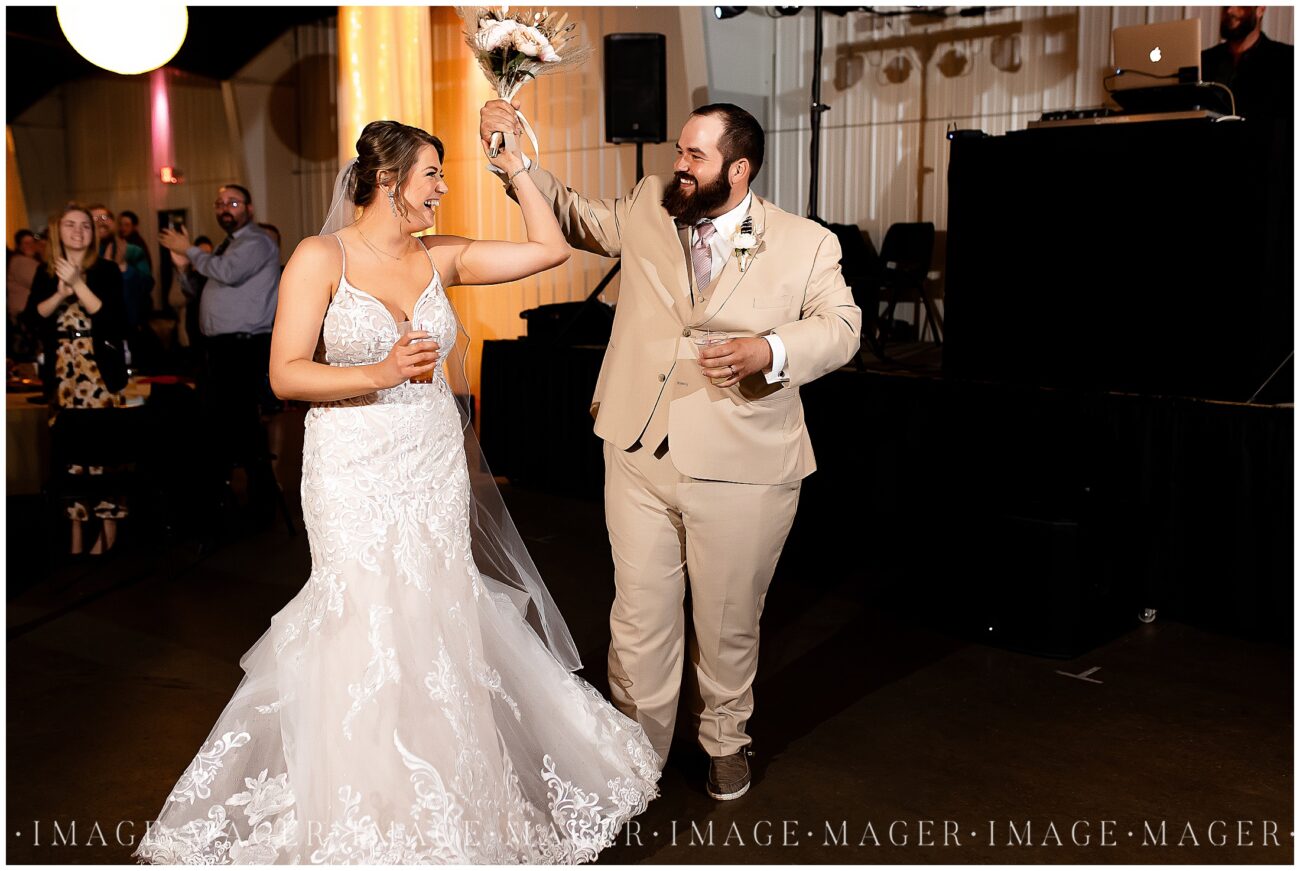 A small town wedding for Casey and Adam. The bride and groom dance and smile at each other as they enter their large wedding reception at the Kankakee County Fairgrounds.

Kankakee County Fairgrounds, Kankakee, IL.

Photo taken by Mager Image Photography.