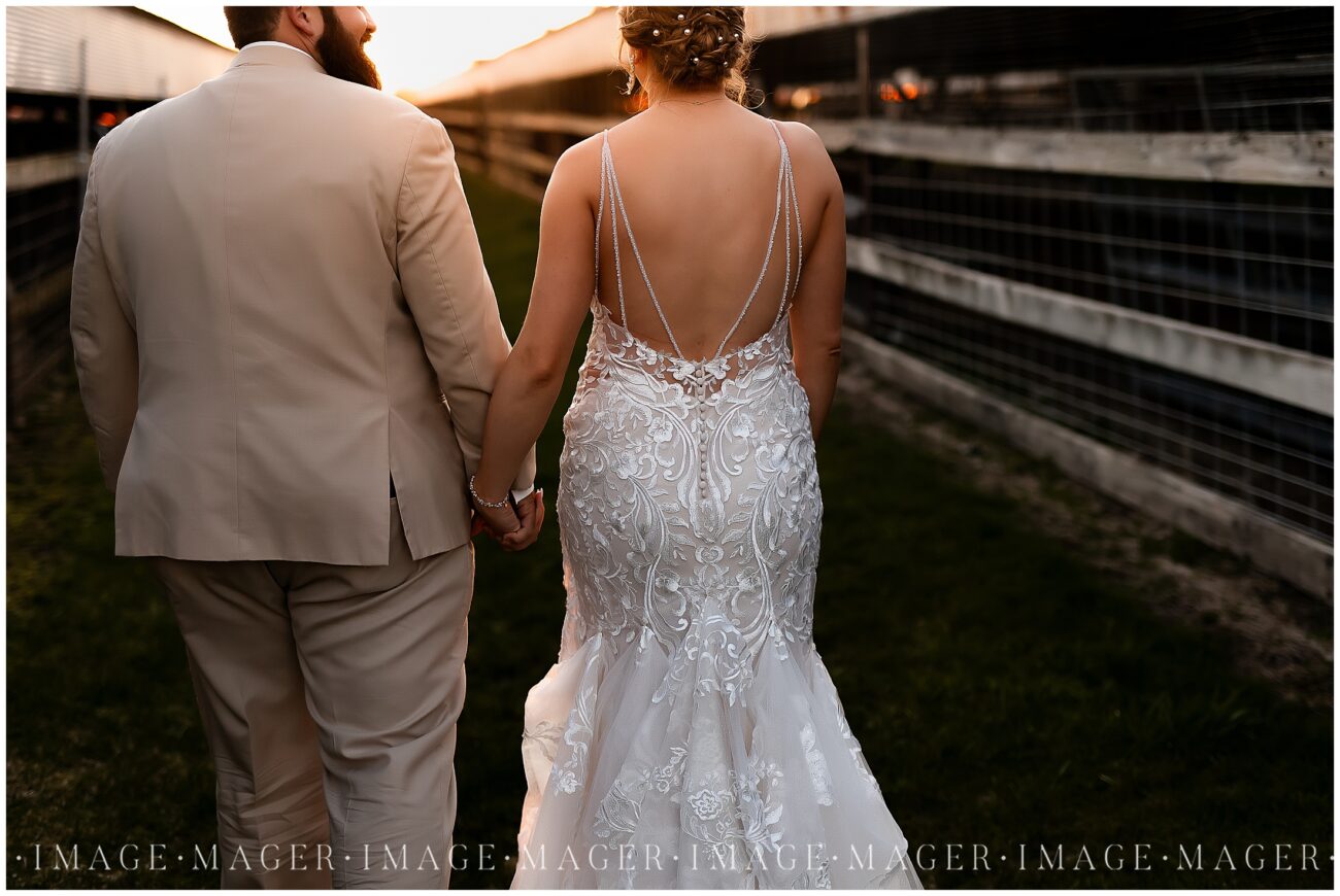 A small town wedding for Casey and Adam. The bride and groom walk away from the camera down a pathway near a barn at the Kankakee County Fairgrounds.

Kankakee County Fairgrounds, Kankakee, IL.

Photo taken by Mager Image Photography.